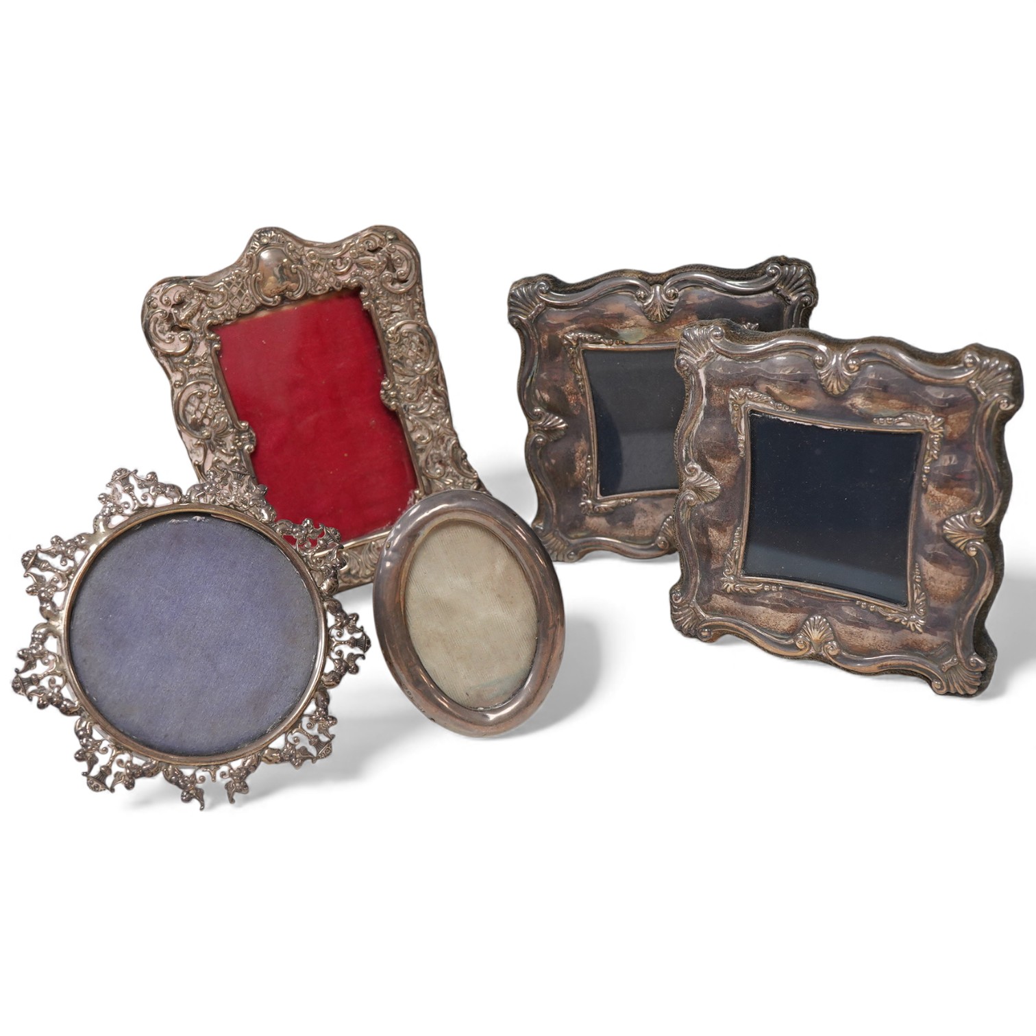 A late Victorian repousse silver mounted small photograph frame, Chester, 1898, 13.1cm, together with two other late Victorian silver mounted photograph frames, including small oval and pierced border and a pair of moder